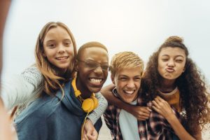Adolescent Mental Health Treatment Facility four teens playfully taking a selfie