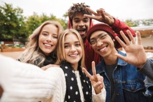 Clinical Approach to Mental Health four teens making peace sign taking a selfie