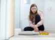 Teen girl struggling with eating disorders vs disordered eating