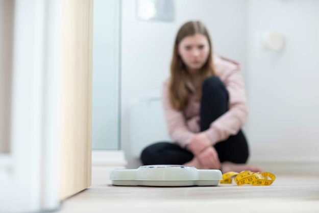 Teen girl struggling with eating disorders vs disordered eating