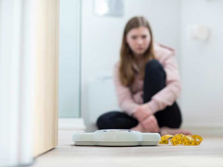 Teen girl struggling with eating disorders vs disordered eating