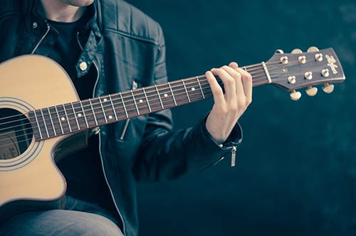 teen with guitar