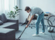 male teen with ocd symptoms cleaning floor with vacuum