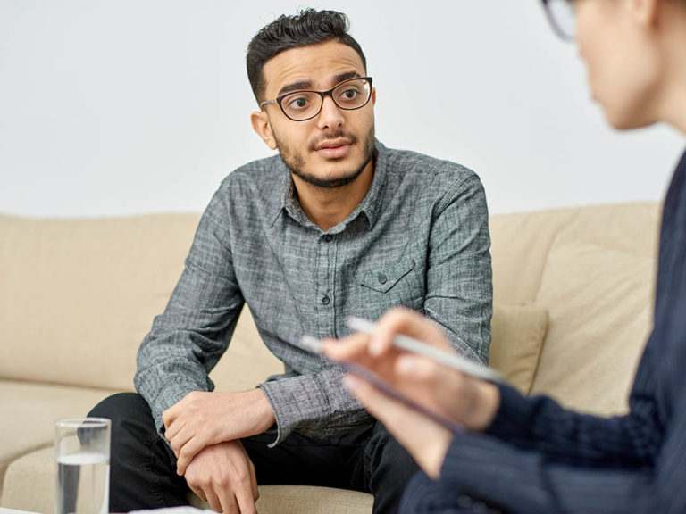 Teenage male learning how to talk to a therapist