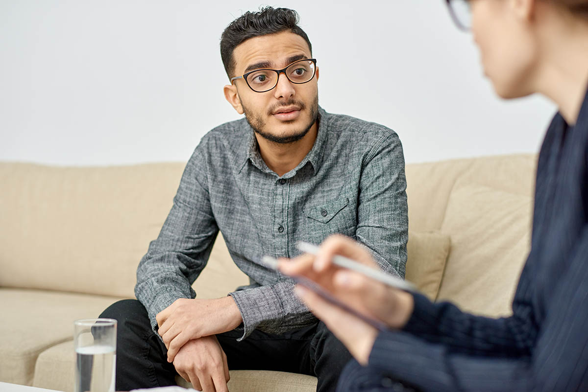 Teenage male learning how to talk to a therapist