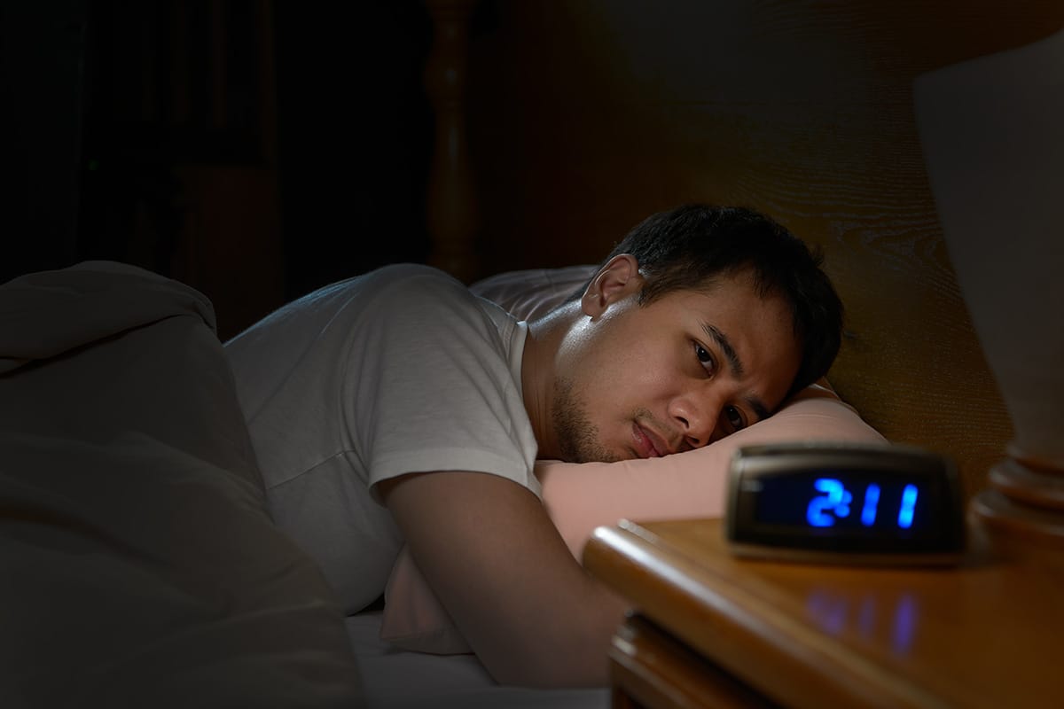 teen in bed balancing sleep and mental health