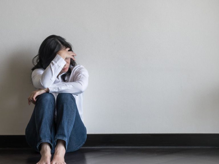 girl sitting by wall wondering does anxiety get worse over time