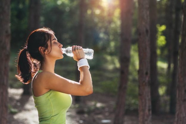woman drinking water and learning about good mental health habits