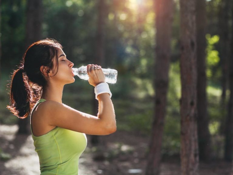 woman drinking water and learning about good mental health habits