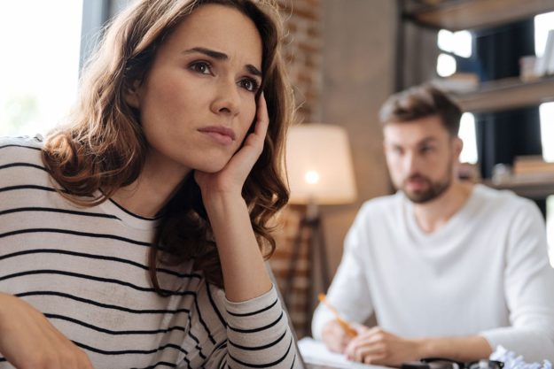 woman in striped shirt sitting across from man wonders about chronic conditions vs mental illness