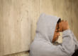 teen in grey hoodie considers the effects of trauma vs ptsd