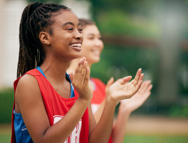 girl clapping at sports practice learns how to motivate yourself