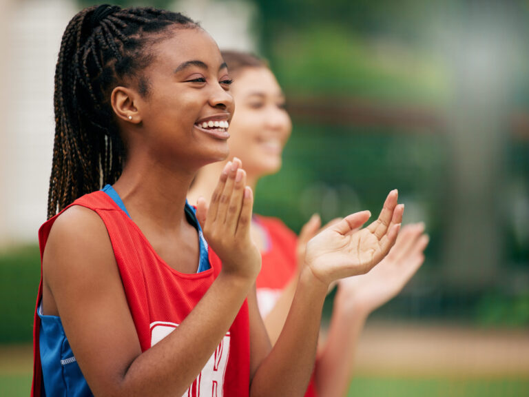 girl clapping at sports practice learns how to motivate yourself