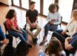 people talk in a circle about mental health first aid