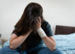 teen sitting on bed thinking about their self-harm motivations