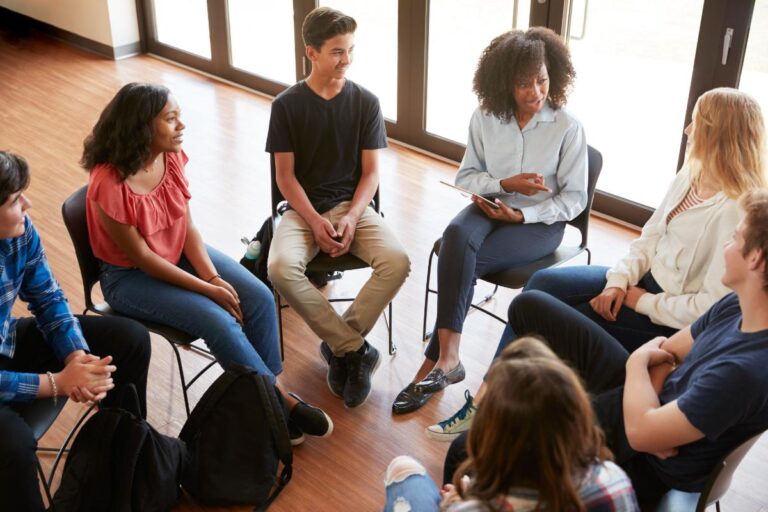 teens in a circle learn how to help a friend seek mental health support