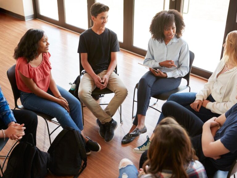 teens in a circle learn how to help a friend seek mental health support