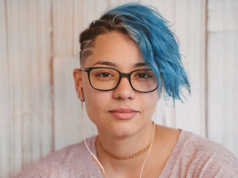 teen standing by wall learns about what is masking in mental health