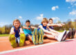 teens outside on a track stretching and discovering how physical activity improves mental health