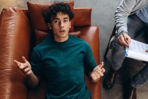 a teen talks to a therapist during trauma treatment
